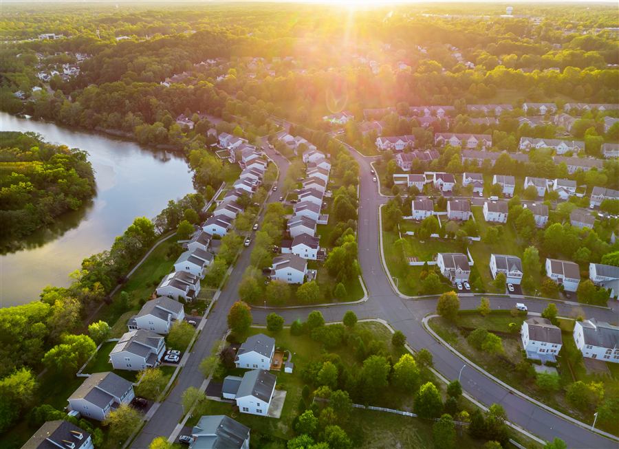 Aerial view of suburban rooftops at sunrise